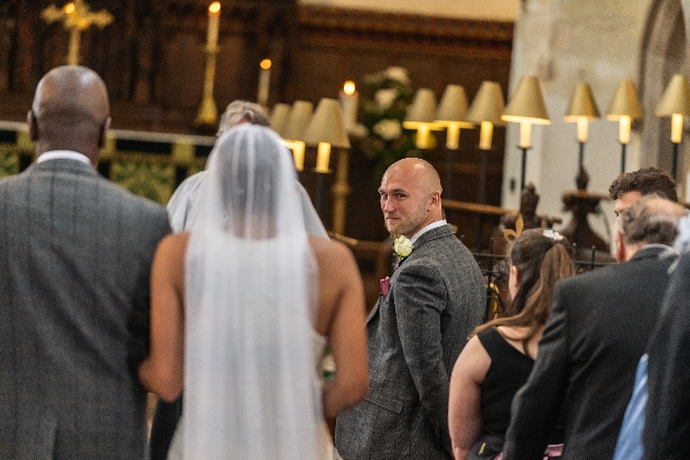 Groom looks back at bride