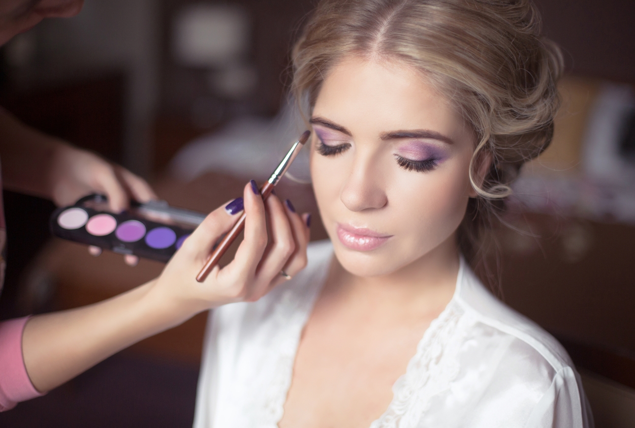 Bride sits whilst make-up artist Heather Card applies makeup