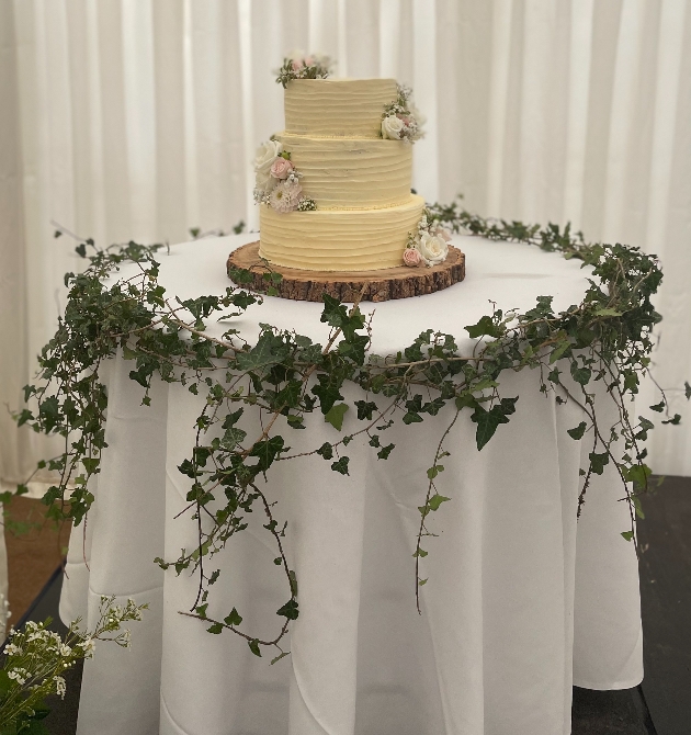 Wedding cake on a log on a table