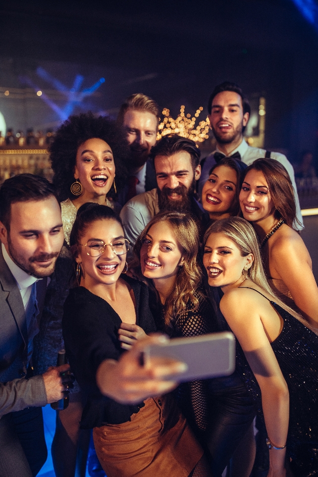 A group of men and women taking a selfie