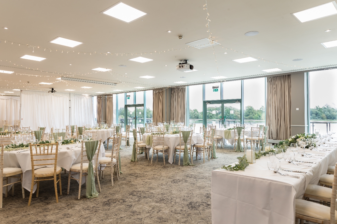 De Vere Cotswold Water Park reception suite with tables for wedding breakfast 